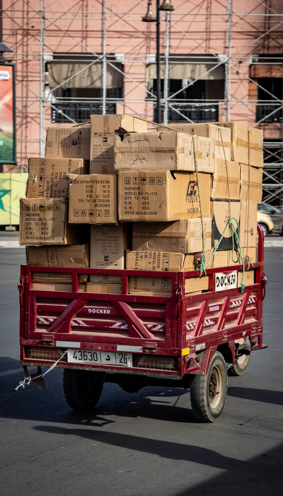 red-trailer-loaded-with-cardboard-boxes-on-street-v-aytrqbuny